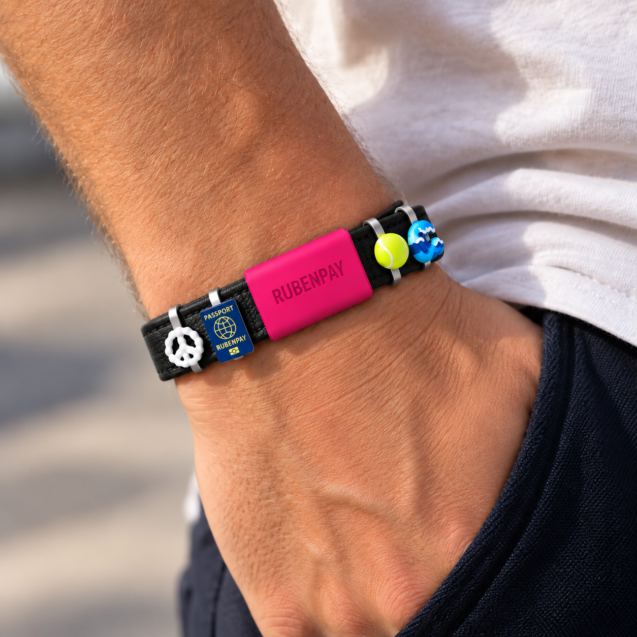 LOOP worn on the wrist with charms, in sunlight